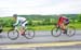 Guillaume Boivin and Charles Dionne make their way back through the caravan after flats  		CREDITS: Rob Jones  		TITLE: Grand Prix de Beauce  		COPYRIGHT: CANADIANCYCLIST