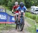 Samuelle Baillargeon (Canada) getting photo bombed by Natalia Marie Torres Macouzet (Mexico) 		CREDITS:  		TITLE: World MTB Championships, 2019 		COPYRIGHT: Rob Jones/www.canadiancyclist.com 2019 -copyright -All rights retained - no use permitted without 
